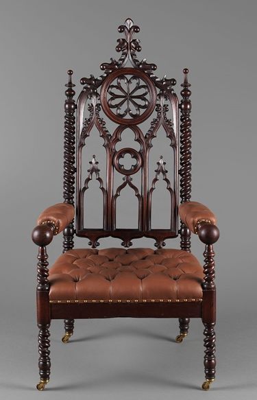 An elaborately crafted wooden armchair with vinyl cushioning