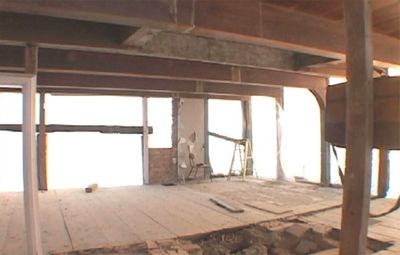 Bare wooden framing of a partially dismantled house.