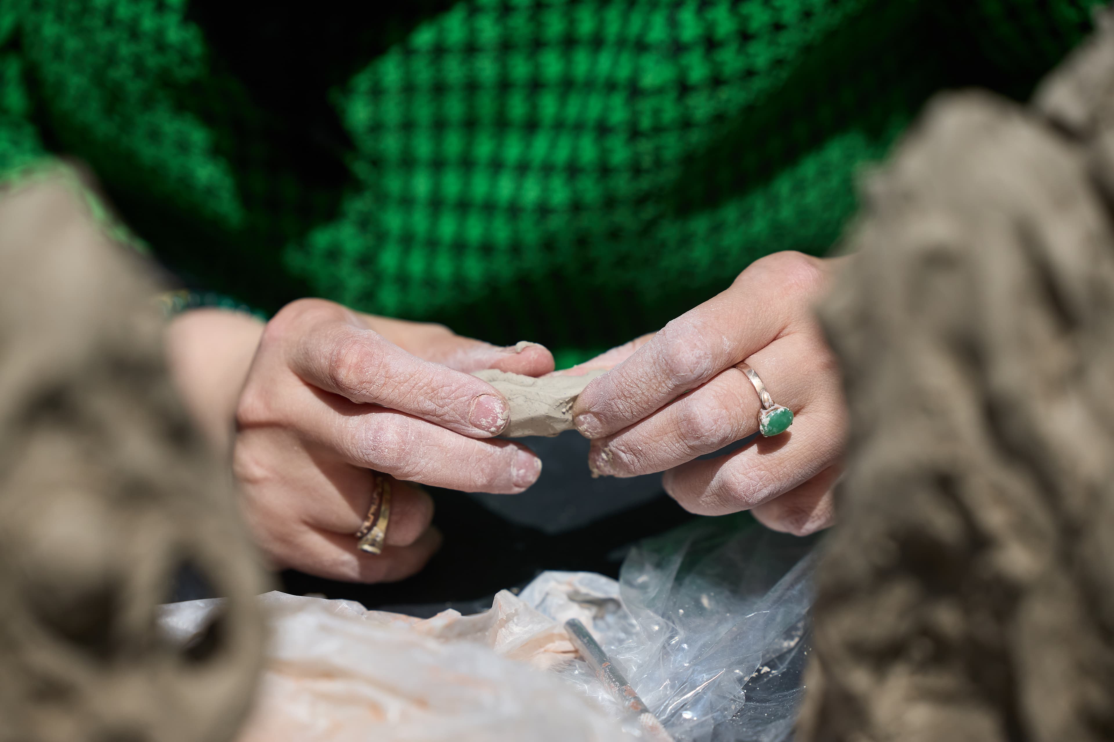 Hands of artist working with clay.