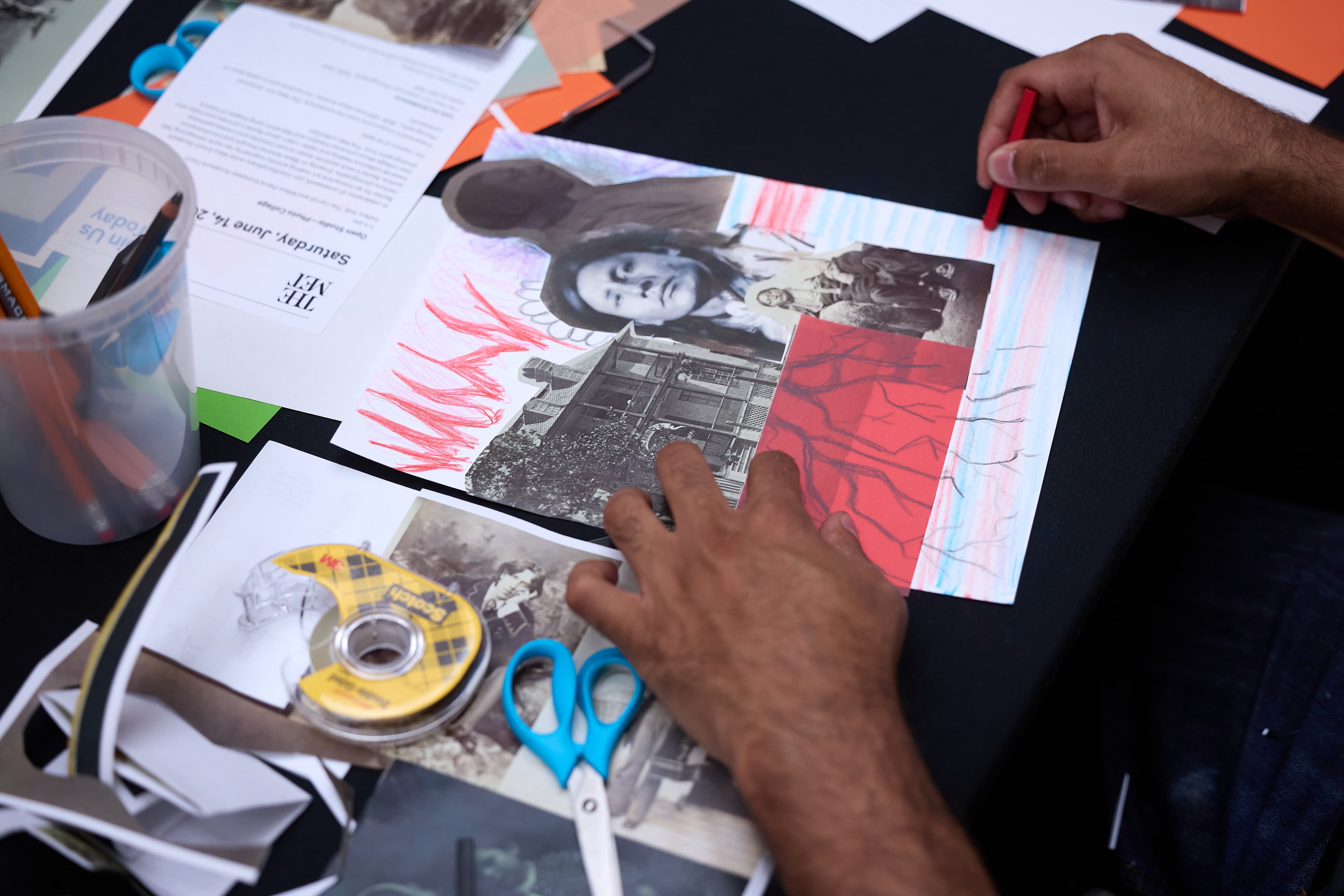 Hands of a program participant making a collage.